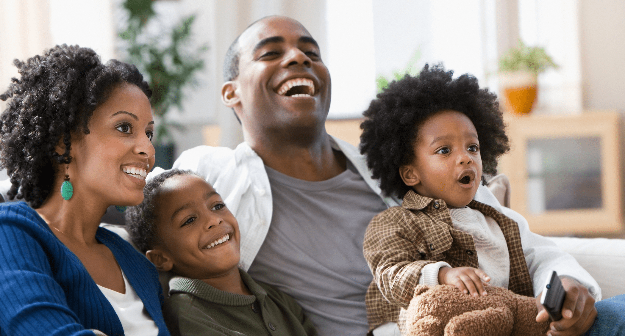 Family on couch laughing