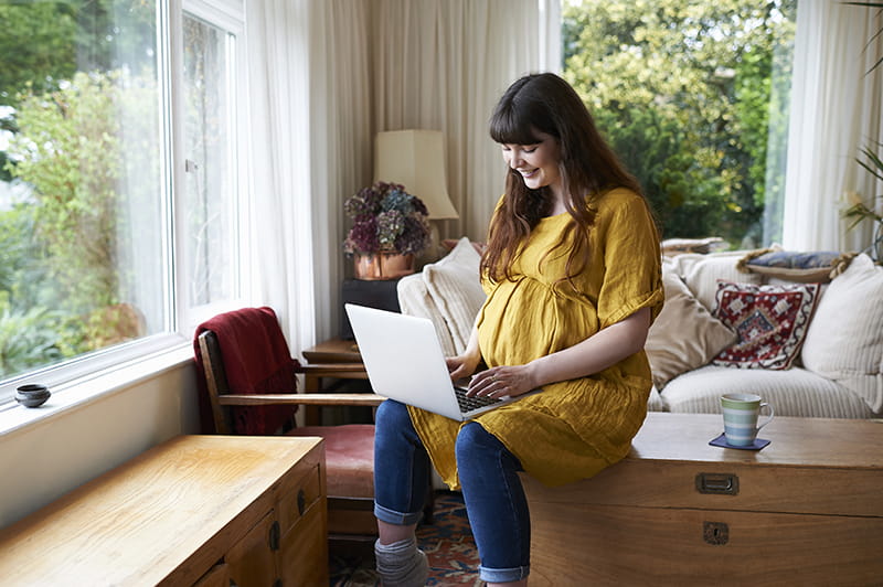 pregnant woman on computer