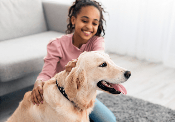 Young girl petting dog