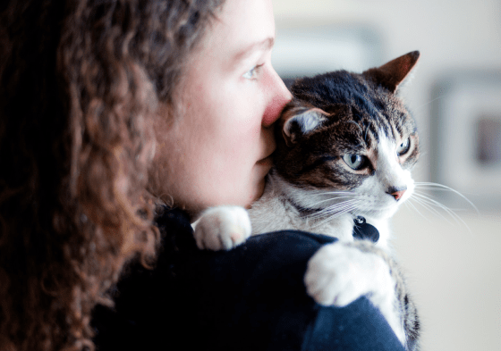 Young woman holding her cat