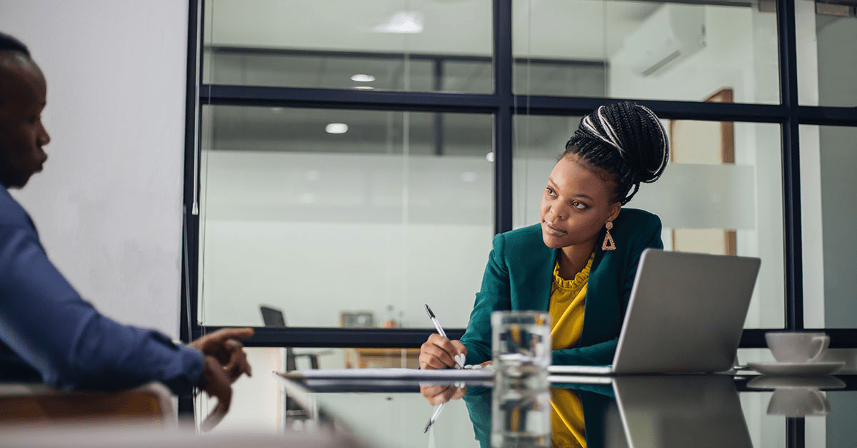 Two people at a conference table