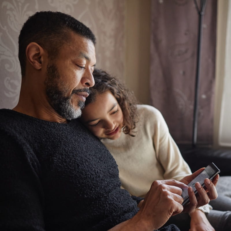 father making a call on phone with child