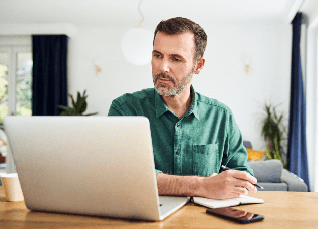 man at desk looking at screen