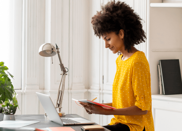 woman at desk looking at phone