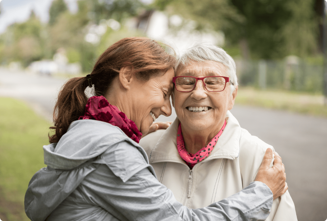 Woman hugging elderly mother