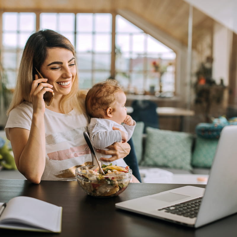 Mom on phone holding baby