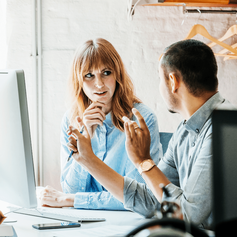 Man and woman having discussion at a computer